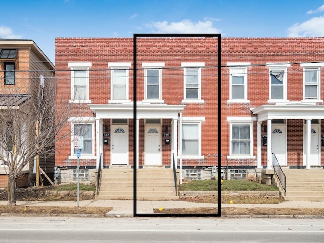 townhome / multi-family property featuring brick siding