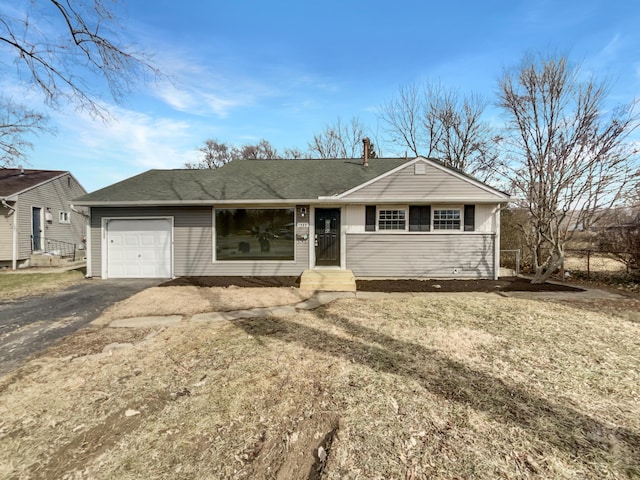 single story home featuring roof with shingles, driveway, and an attached garage