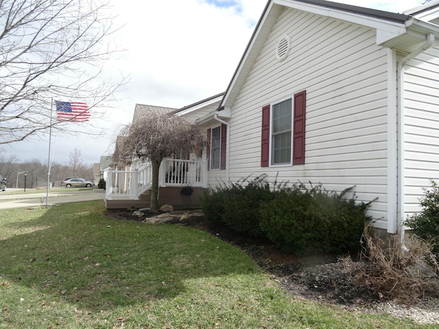 view of home's exterior with a yard