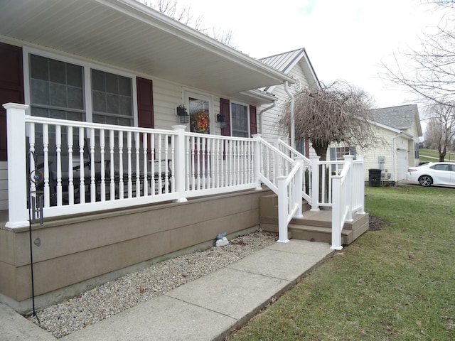 view of side of property with a porch, metal roof, and a lawn