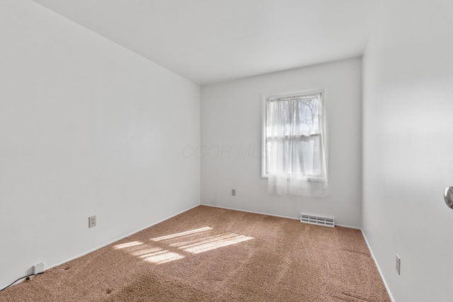 carpeted spare room with visible vents