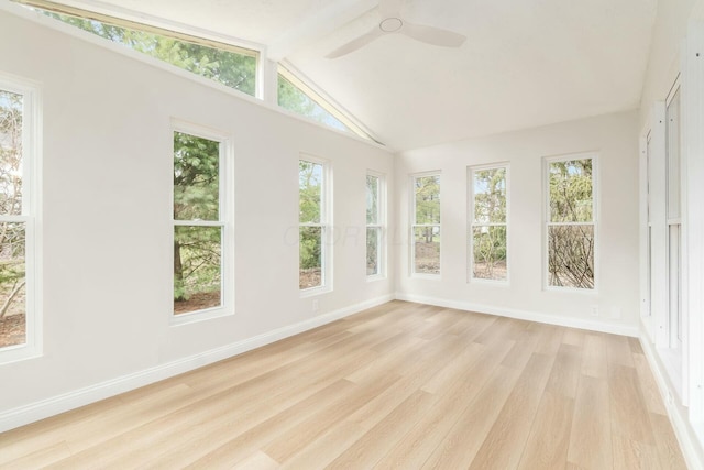 unfurnished sunroom featuring a ceiling fan and vaulted ceiling with beams