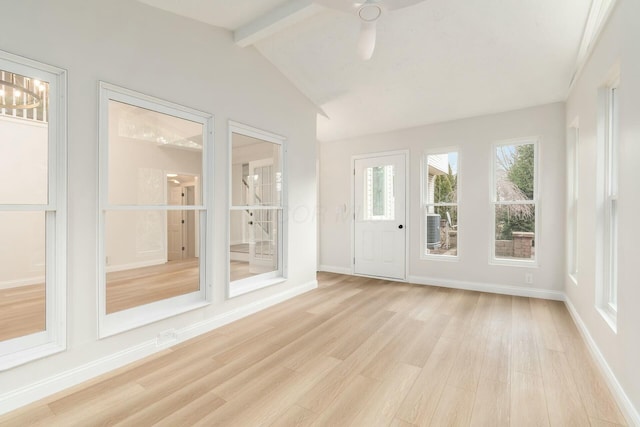 unfurnished sunroom with vaulted ceiling with beams and a ceiling fan