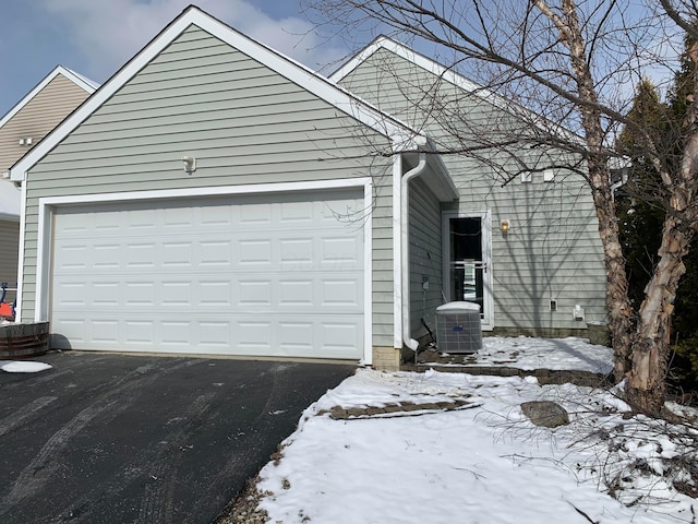 exterior space featuring driveway and central air condition unit