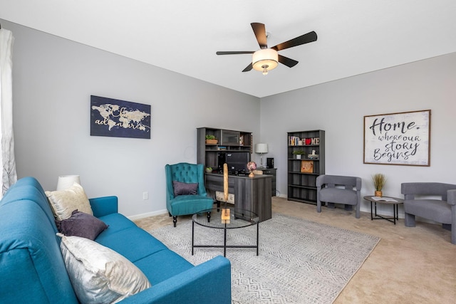 living room with carpet flooring, ceiling fan, and baseboards