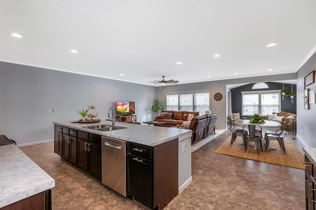 kitchen featuring a center island with sink, light countertops, a sink, and open floor plan