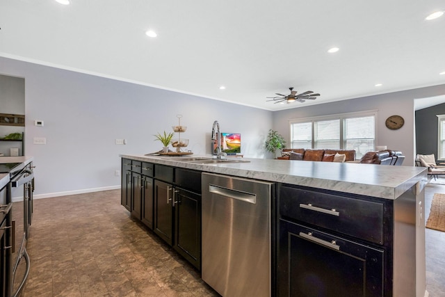 kitchen featuring a center island with sink, dishwasher, open floor plan, light countertops, and a sink