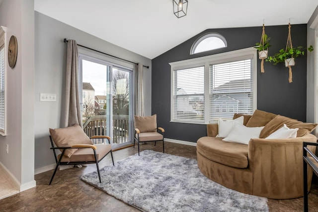 living area with vaulted ceiling and baseboards