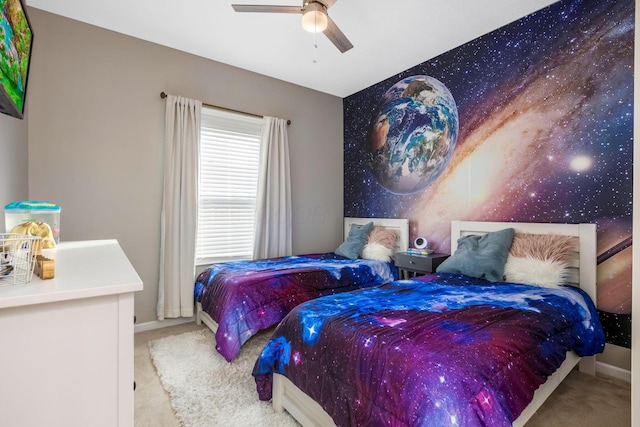 bedroom featuring ceiling fan, baseboards, and light colored carpet