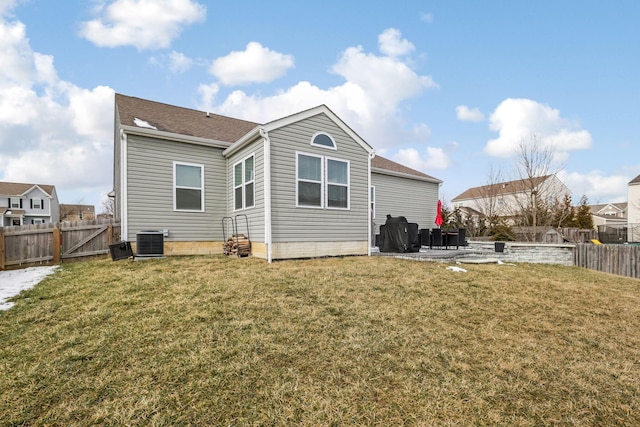 back of house featuring a patio area, a fenced backyard, and a yard