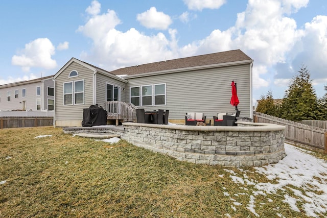 rear view of property with a fenced backyard, a patio, and a yard