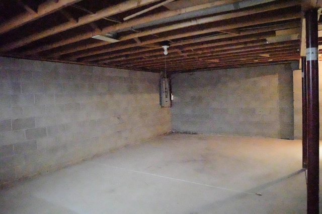 unfinished basement featuring electric panel