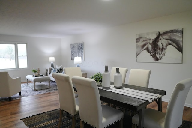 dining area featuring baseboards and wood finished floors