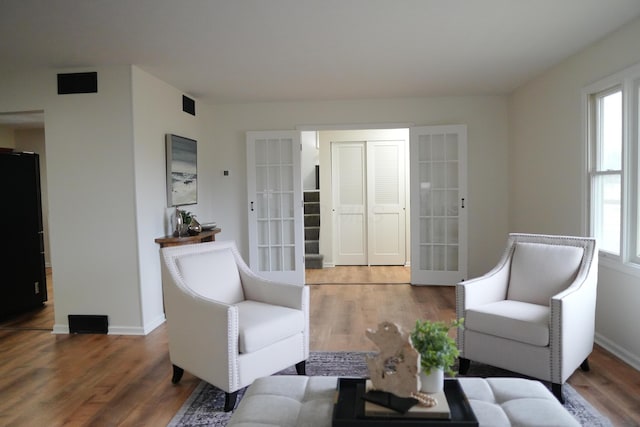 living room with baseboards and wood finished floors