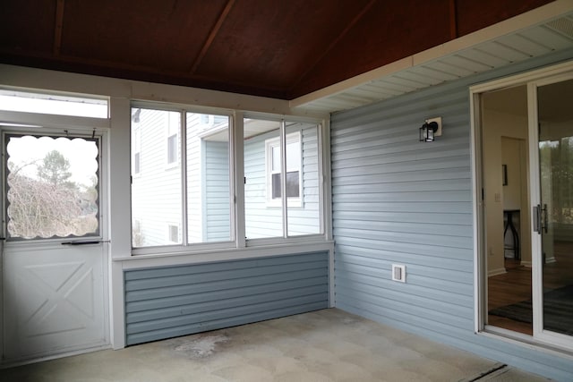 unfurnished sunroom with lofted ceiling