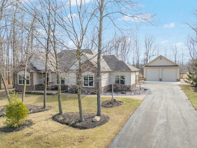 view of front of home with stone siding, a detached garage, an outdoor structure, and a front yard