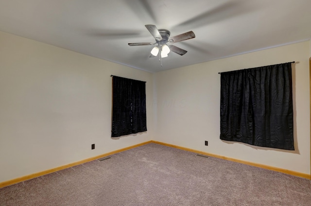 empty room with a ceiling fan, baseboards, visible vents, and carpet flooring