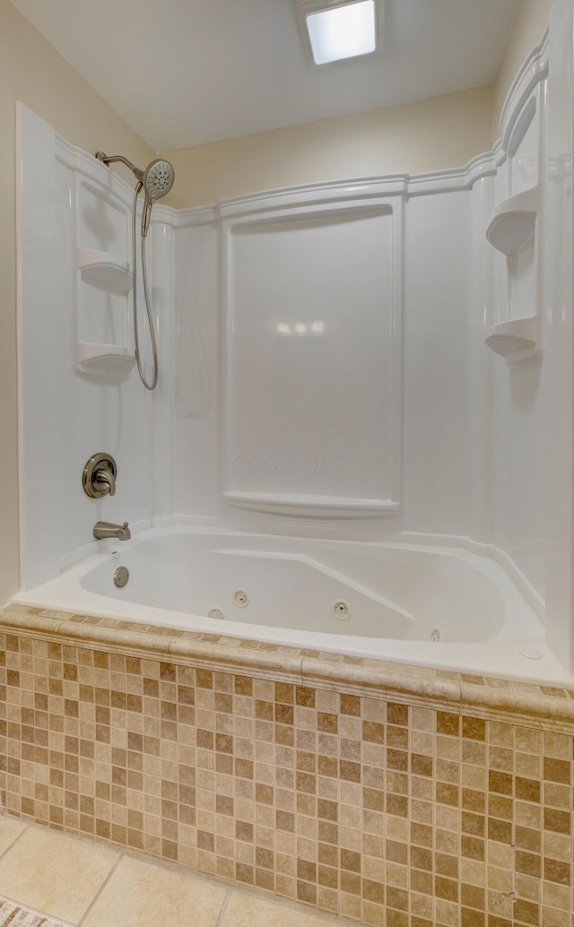 full bath featuring a combined bath / shower with jetted tub and tile patterned flooring