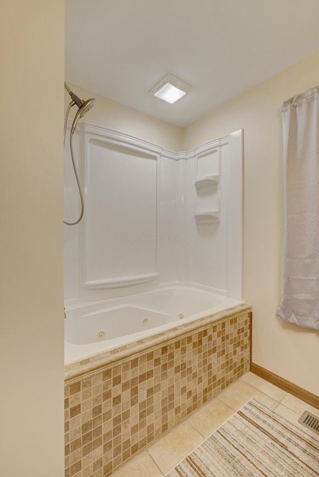 bathroom featuring a combined bath / shower with jetted tub, tile patterned flooring, visible vents, and baseboards