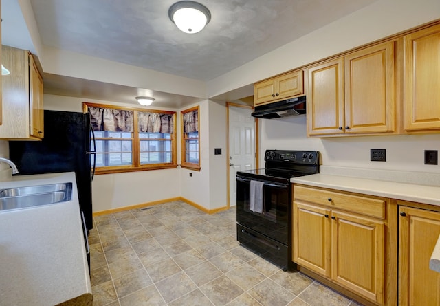 kitchen with baseboards, black electric range oven, light countertops, under cabinet range hood, and a sink