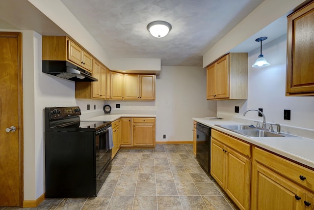 kitchen featuring baseboards, under cabinet range hood, light countertops, black appliances, and a sink