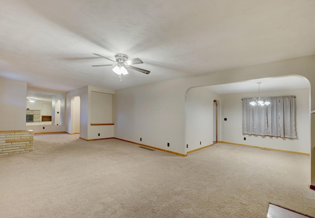 empty room with carpet, visible vents, and baseboards