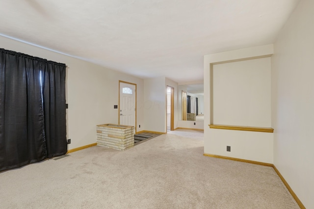 unfurnished room with baseboards and carpet flooring