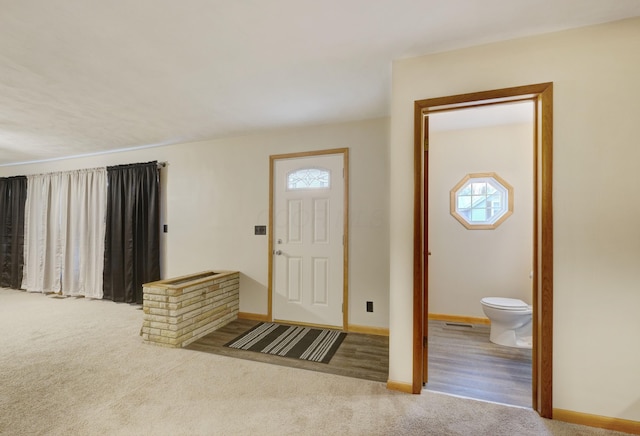 carpeted entrance foyer with baseboards