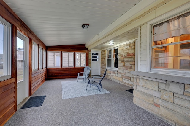 sunroom with a healthy amount of sunlight and vaulted ceiling