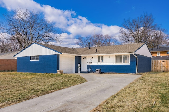 ranch-style house featuring an attached garage, a front lawn, concrete driveway, and brick siding