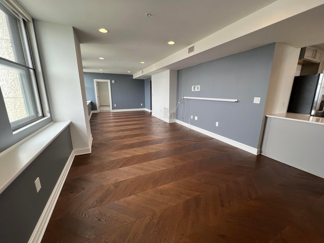 unfurnished room featuring recessed lighting, visible vents, and baseboards