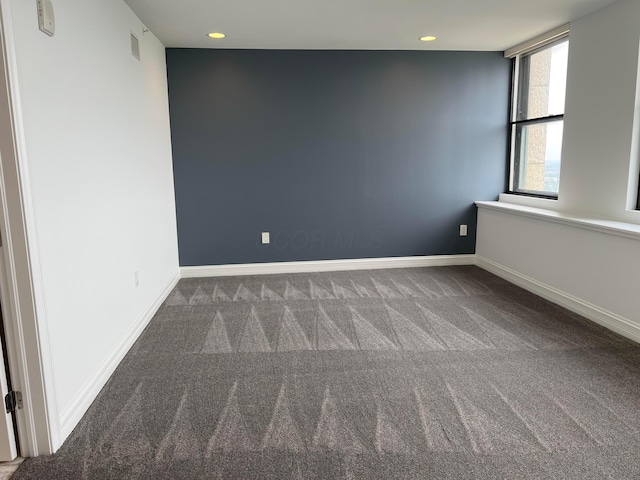 carpeted empty room featuring recessed lighting and baseboards