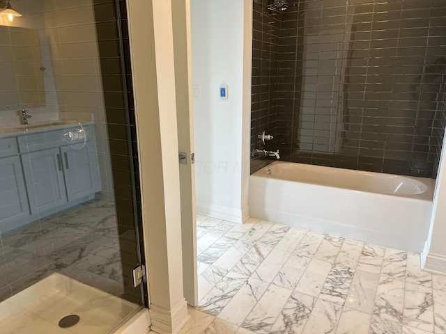 bathroom featuring a washtub, marble finish floor, a shower stall, vanity, and baseboards