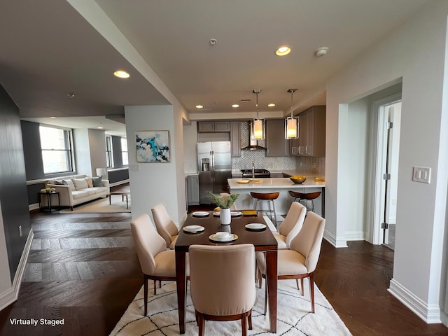 dining space with baseboards, dark wood-type flooring, and recessed lighting