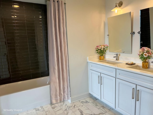 full bathroom with marble finish floor, shower / bath combo, baseboards, and a sink