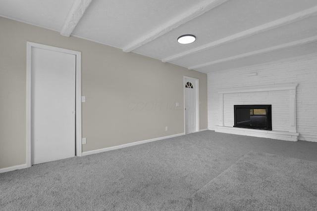 unfurnished living room featuring a textured ceiling, a fireplace, carpet flooring, baseboards, and beamed ceiling