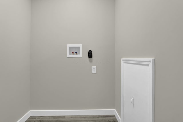 laundry area featuring laundry area, baseboards, washer hookup, and wood finished floors