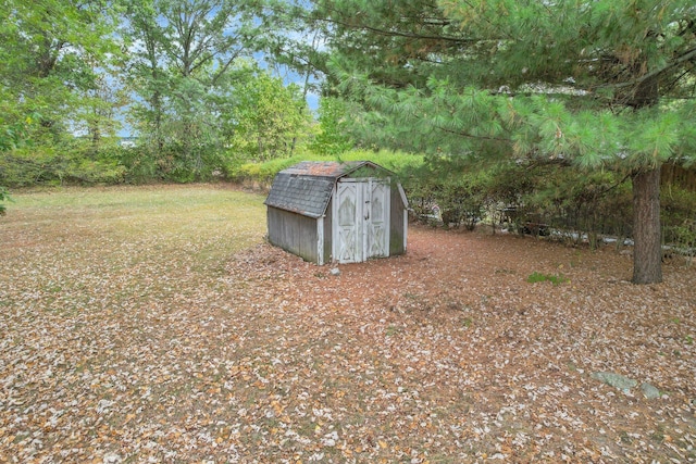 view of yard with a storage shed and an outbuilding