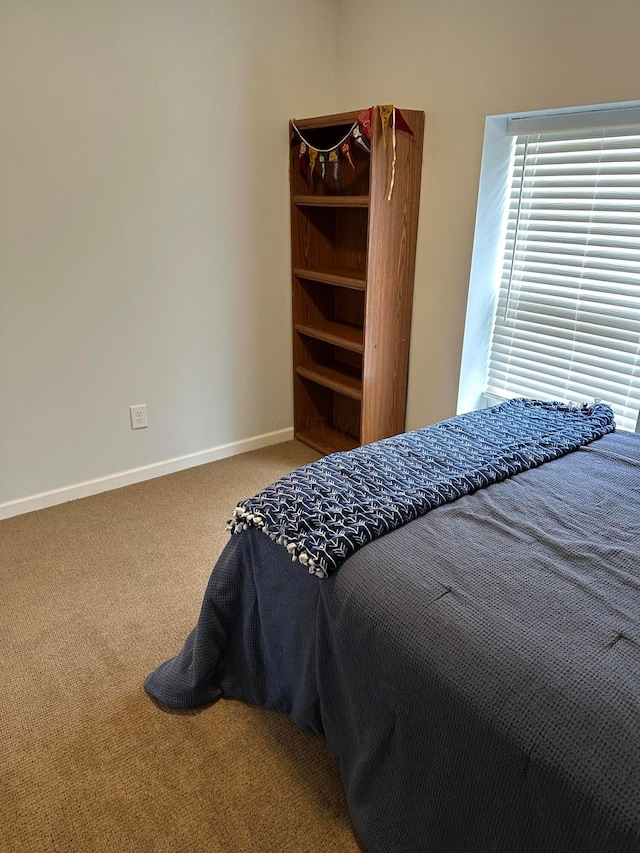 bedroom with carpet and baseboards