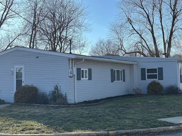 view of side of home with a lawn