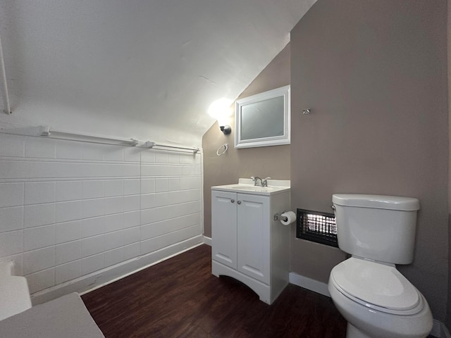 bathroom featuring vaulted ceiling, vanity, wood finished floors, and toilet