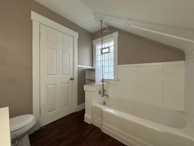 bathroom with toilet, vaulted ceiling, and wood finished floors