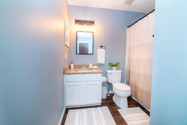 full bath featuring a textured ceiling, toilet, wood finished floors, visible vents, and vanity