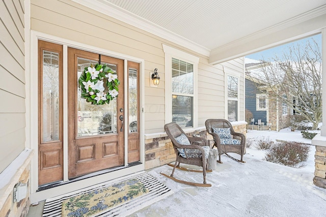 view of snow covered property entrance