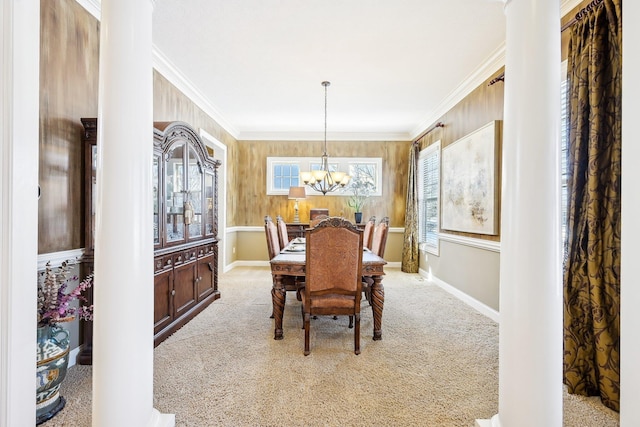 dining space with a chandelier, light carpet, crown molding, and baseboards