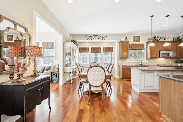 dining area featuring light wood finished floors, a wealth of natural light, and recessed lighting