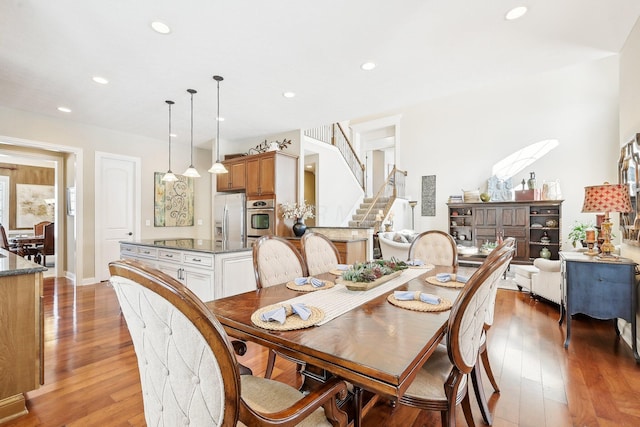 dining room featuring stairway, recessed lighting, and light wood-style floors