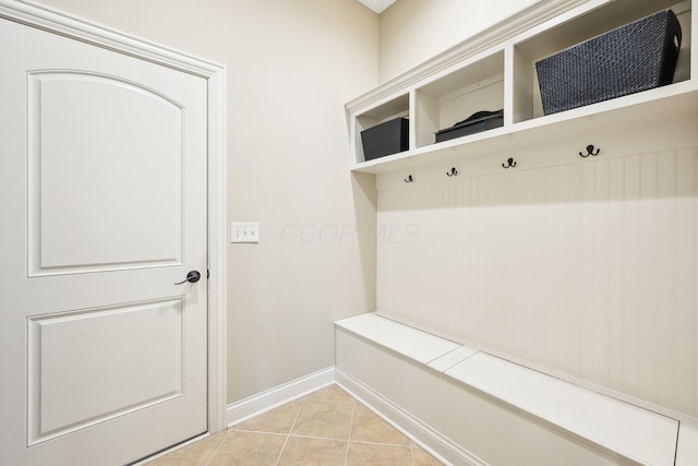 mudroom featuring light tile patterned floors and baseboards