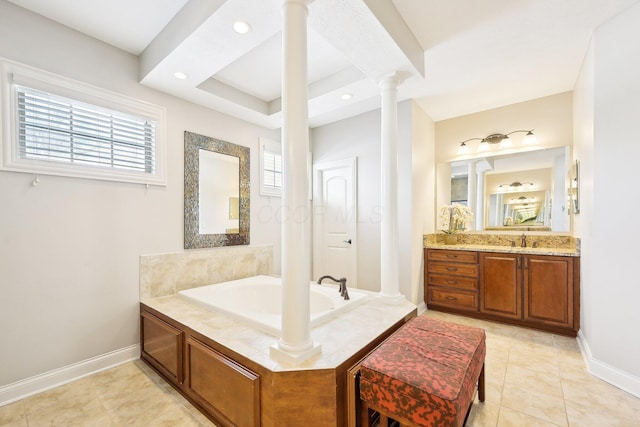 bathroom with decorative columns, baseboards, a garden tub, tile patterned flooring, and vanity