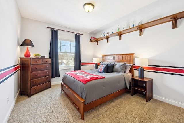 bedroom with baseboards and light colored carpet